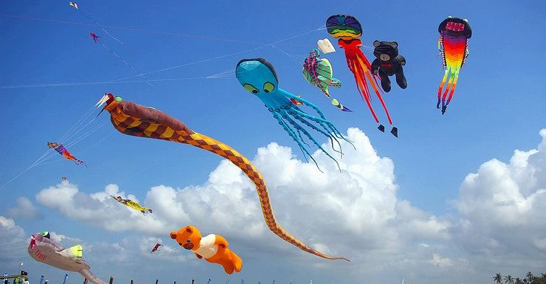 Colorful giant kites soaring above the beach during the Bali Kite Festival Sanur