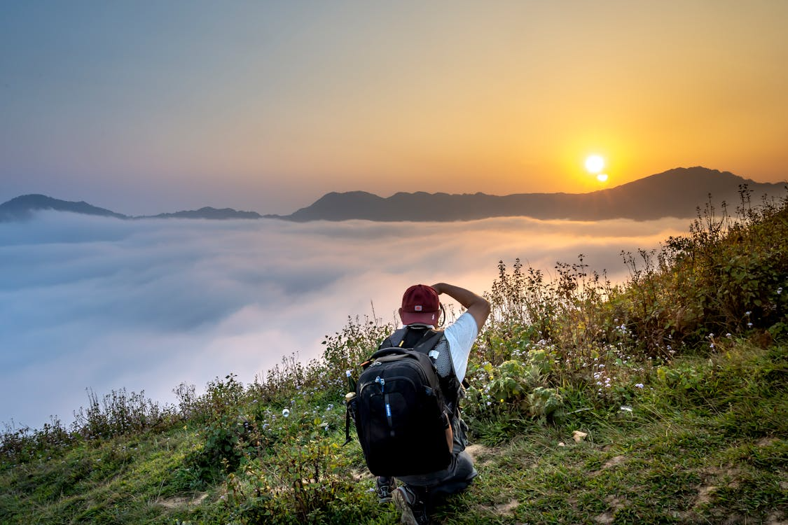 Travelers exploring a Bali volcano through guided treks, sunrise hikes, and panoramic lookouts overlooking lush valleys, lakes, and surrounding countryside.