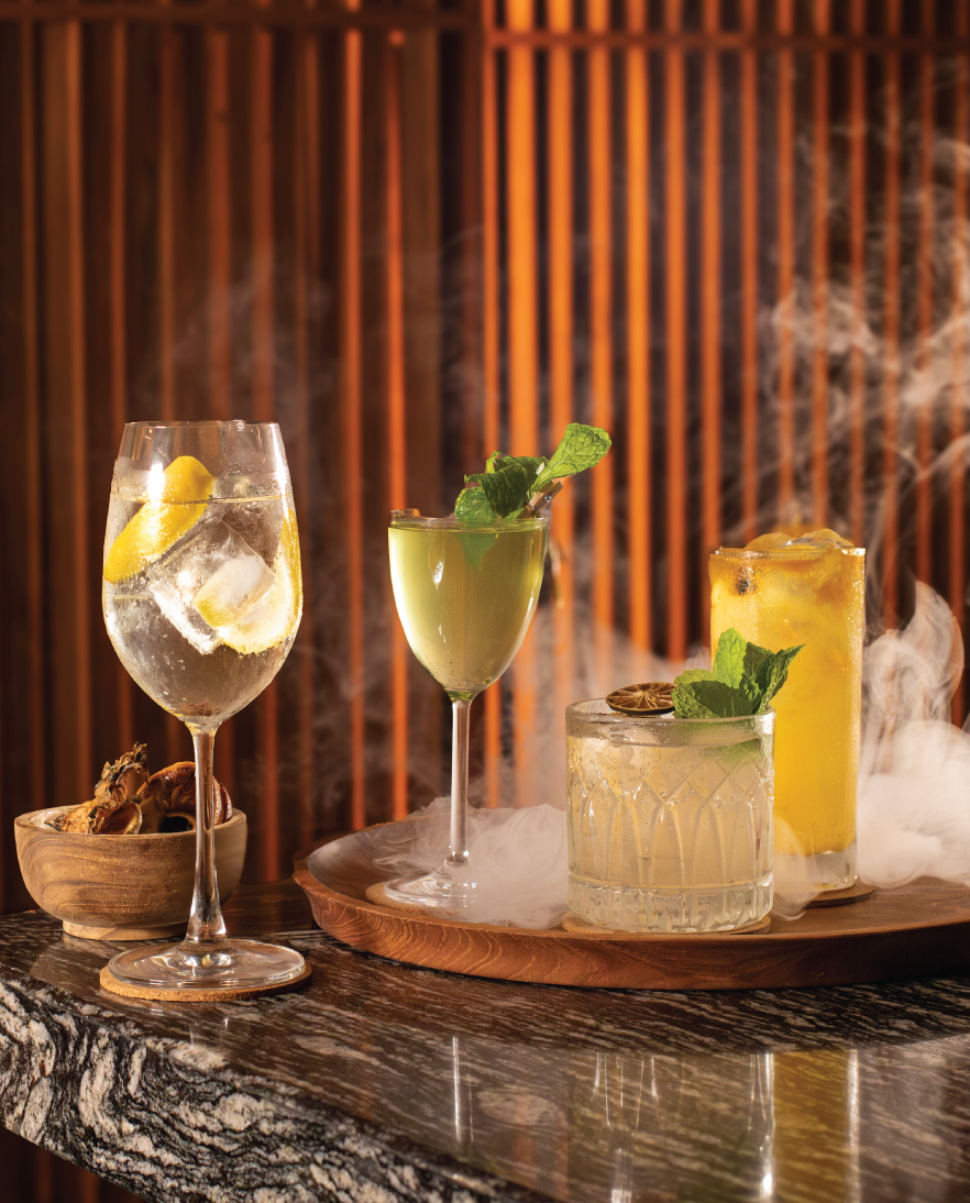 Travelers enjoying the best beach bars in Bali, relaxing by the sea with refreshing drinks, vibrant atmospheres, and panoramic views of the Indian Ocean.