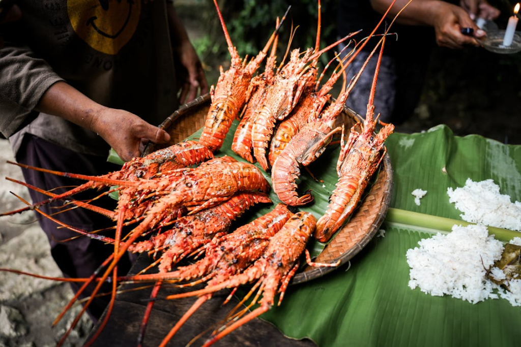 Diners enjoying the best seafood restaurants in Bali, featuring grilled seafood platters, local specialties, and stunning ocean views across the island.