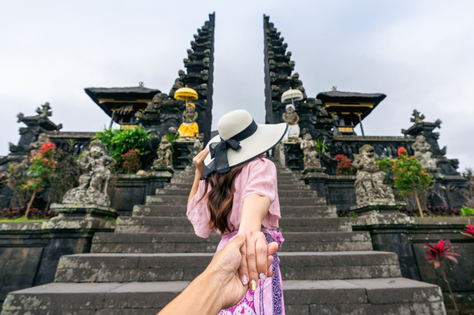 Travelers enjoying the best things to do in Bali, from surfing and snorkeling to visiting waterfalls, local markets, and iconic sunset viewpoints.