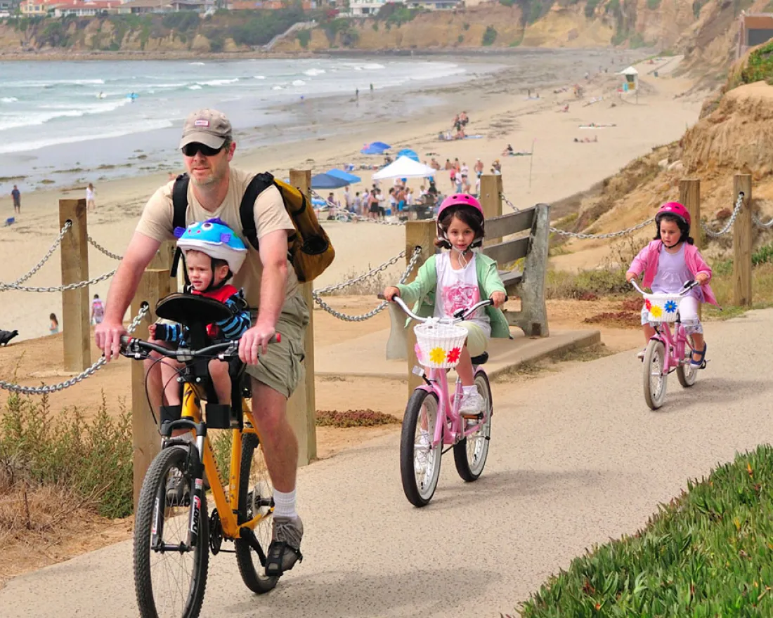 Family cycling through rice terraces as part of the best things to do in Bali with kids